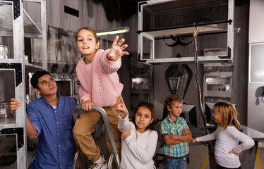 Excited tweenagers trying to find solution of conundrum in closed space of lost room-bunker..