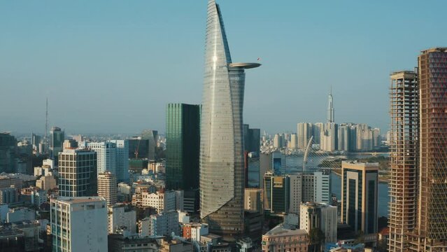 Aerial zoom shot from flying drone of Bitexco Financial Tower Skyscraper in Ho Chi Minh city, Vietnam. Modern urban architecture in financial center, daytime