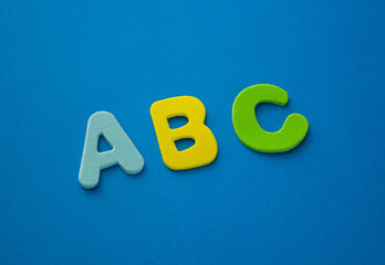 Green, Blue, yellow ABC letters alphabet on blue background. Learn foreign languages. English for...