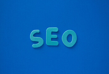 The word SEO made from blue letters on a blue background. Blue letters as SEO abbreviation Search...