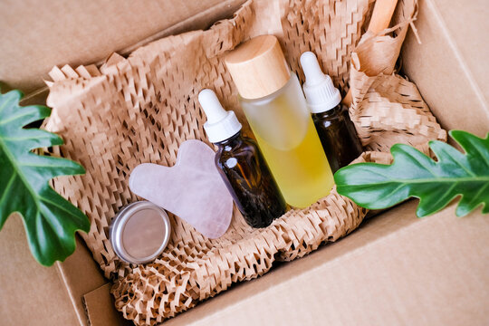 the skincare product and beauty cosmetic in the eco friendly shipping box with green leaves. plastic free , zero waste and recycling concept for packaging.