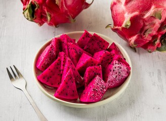 Freshly sliced ​​red dragon fruit with raw fruits cut served in disposable glass isolated on background top view taiwan food