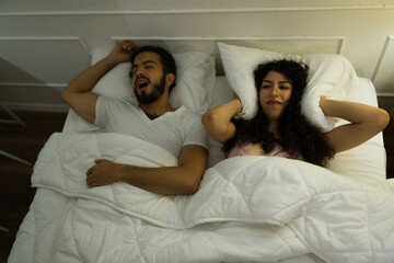 High angle of a woman upset about her partner snoring
