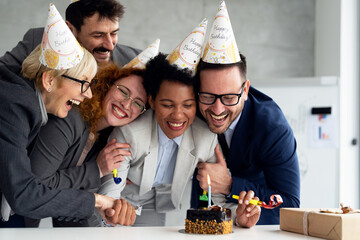 Business people celebrating birthday of his colleague at office