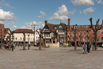 Salisbury, Wiltshire, England, UK. 2023. People walk on Market Place in the city centre surrounded with historic buildings, shops and offices. - obrazy, fototapety, plakaty
