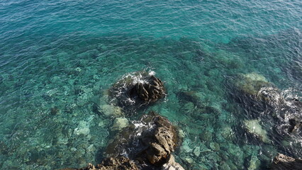 Fototapeta na wymiar Crystal clear ocen water with volcanic rocks visible on the bottom in Tenerife, Canary Islands, Spain