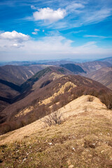 Fototapeta na wymiar Springtime panorama of the Ligurian Apennines, towards the Piedmont side, seen from the top of Antola mountain; is a small peak on the borders between Piedmont and Liguria (Northern Italy).