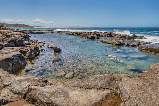 A beautiful natural rock pool on the coast at Angourie Point Beach, Angourie, NSW, Australia
