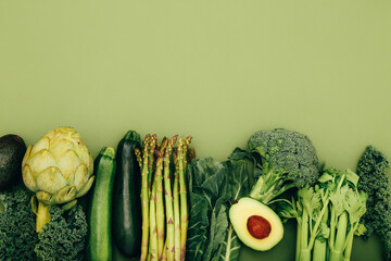 Organic healthy green vegetables on colorful background, top view