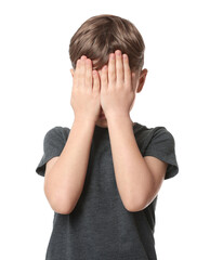 Fototapeta premium Boy covering face with hands on white background. Children's bullying