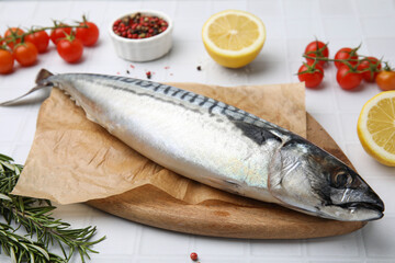 Raw mackerel and rosemary on white table