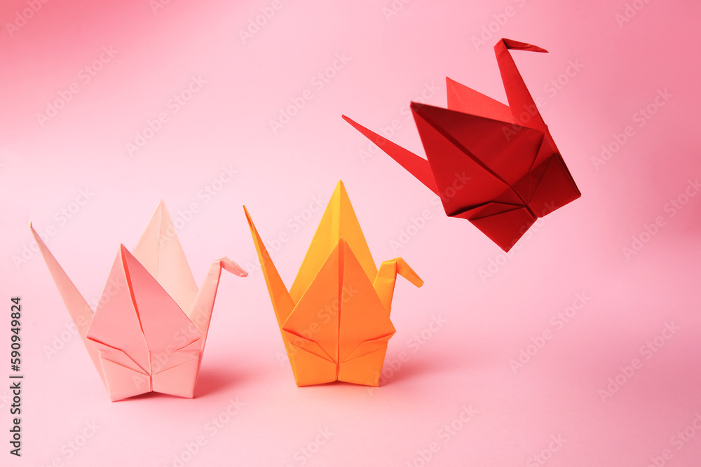 Canvas Prints Colorful paper origami cranes on pink background