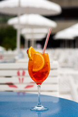 Tropical Gin cocktail with orange and strawberry on a summer day