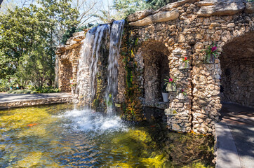 Beautiful manmade waterfalls and brick wall in the public park in Dallas, Texas