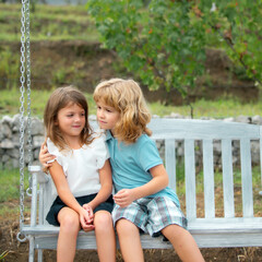 Two children outdoors. Portrait of adorable brother and sister smile and laugh together while...