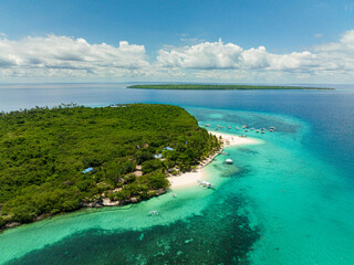 Aerial drone of island with a beach in the tropics. Virgin Island, Philippines.