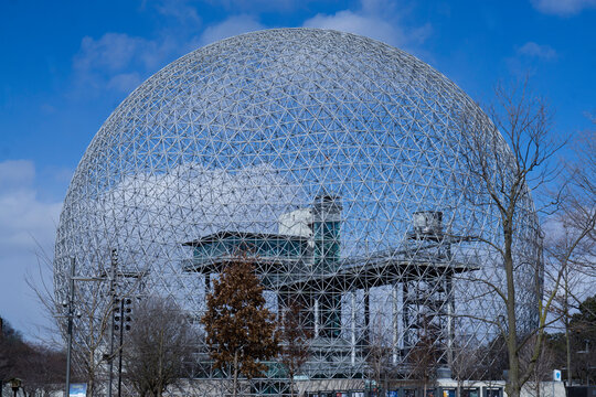 MONTREAL-CANADA -10 April 2023: View of the blue sky through a detail of the steel structure of the dome at the Biosphere environment museum in Montreal, Quebec, Canada.