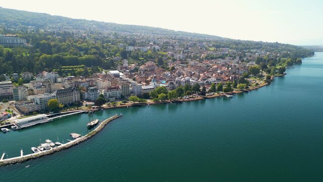 Stunning aerial drone shots of the french lake side town of Evian Les Bains. Situated on the clear blue waters of Lake Geneva on the Swiss, French Border and surrounded by high alpine peaks.