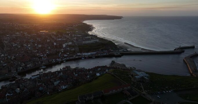 Whitby headland at sunset, dark shadows, pier abbey and town - aerial footage prores 4k Clip 2