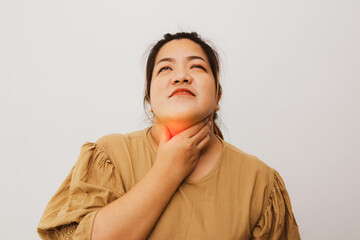 Asian obese woman having abnormal symptoms holding her neck with her hands because of pain feeling...