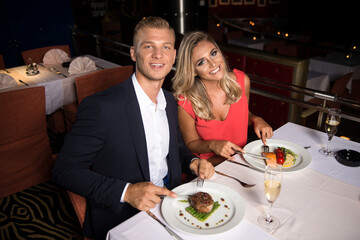 Romantic Young Couple At Restaurant Eating Food