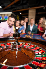 Young Couple Behind Roulette Table in a Casino