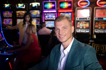 Happy Man Playing Arcade Machine in a Casino