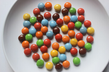 colorfull chocolate candies with white plate background