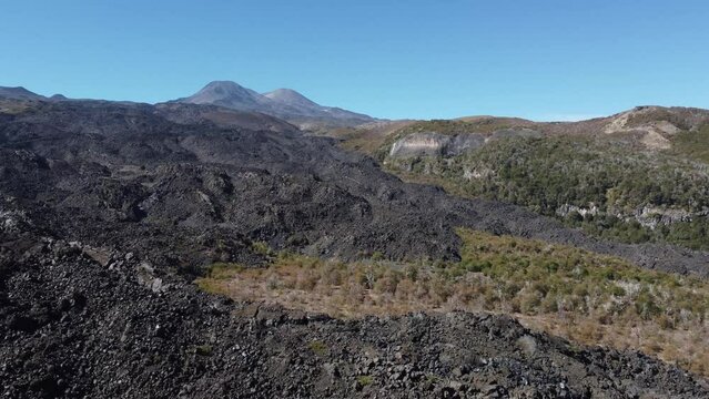 aerial view of a landscape with mountains and volcanic rock roads in chile