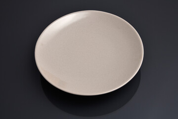 Empty plate on black background