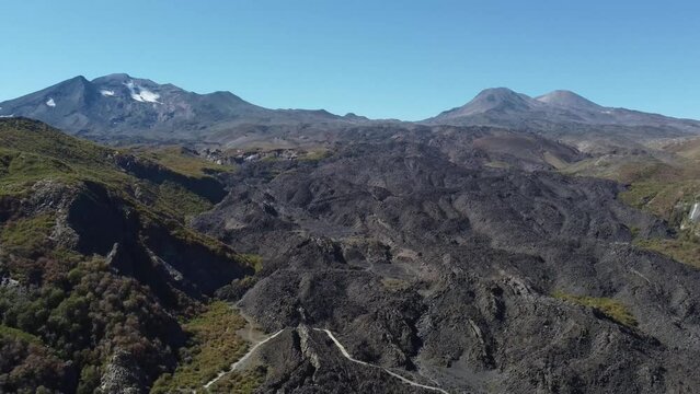 aerial view of routes with volcanic rocks surrounded by mountains