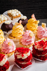 Pastry shop display window with variety of mini desserts and cakes