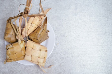 Ketupat (Rice Dumplings) On Silver and white Background. Ketupat is a natural rice shell made from young coconut leaves to cook rice during Eid, Idul Fitri