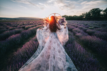 Beautiful bride in a lavender field at sunset.
