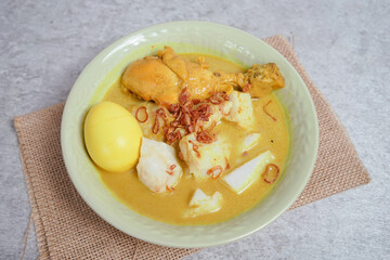 Opor Ayam (Chicken Curry) and Ketupat Lebaran (Rice Cake). Special Eid celebratory dish from Indonesia and Malaysia.