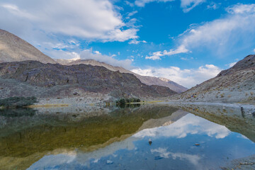 Naklejka na ściany i meble mountains, clouds and sky are reflected on the lake. Beautiful scenery at Yarab Tso valley - Leh Ladakh - India