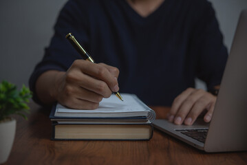 businessman working at desk, using pen and paper to Writing and Planning take notes. concepts business organization, or management, strategy, communication.