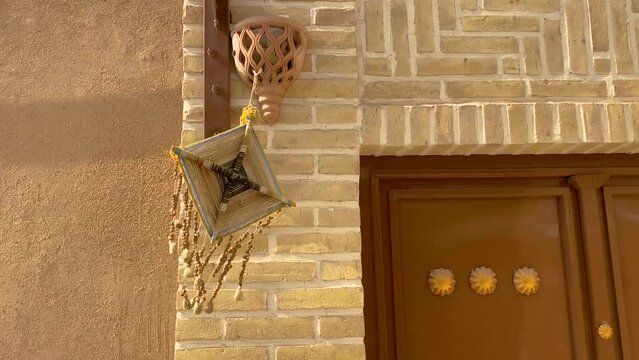 Hanging woven square harmel wild rue plant as a ritual to remove away evil eye local people belief in middle east Asia Persian culture religious activity to get fortune health happiness symbol art 