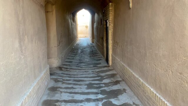 Water salute in alley corridor walkway in desert old city in middle east Asia
narrow winding cobble stone way to greet people guest hospitality Persian house mud clay brick design of traditional house