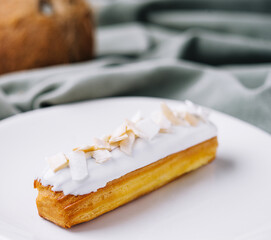 french eclair with coconut on plate