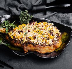 Barbecue tomahawk steak on black plate