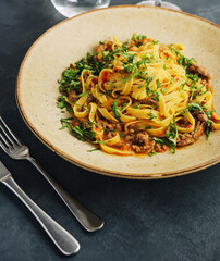 egg pasta tagliatelle with bolognese sauce made from meat and tomato sauce © AntAlexStudio