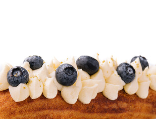Eclair with buttercream and blueberries close up