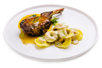 tomahawk steak and ravioli on plate