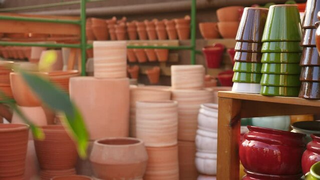 Showcase of home decor shop with various ceramic flower pots for sale 