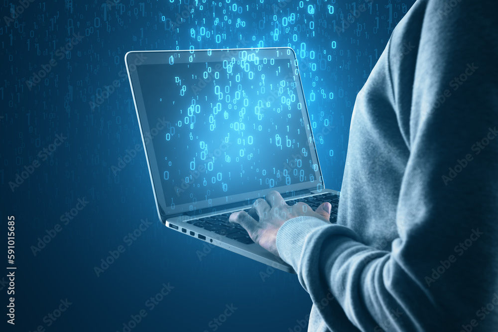 Leinwandbilder Close up of hacker holding laptop with abstract glowing binary code hologram on blue background. Programming, hacking and theft concept.
