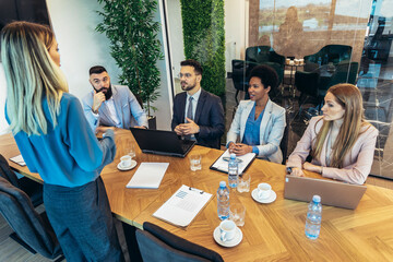 Group of businesspeople having a briefing in a boardroom. Businesspeople working together in a modern workplace.