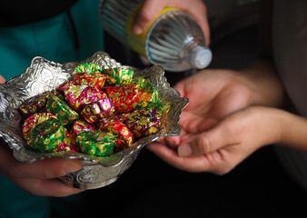 Turkish traditional islamic fiesta culture. Serving chocolat, candies and cologne to the guests or...