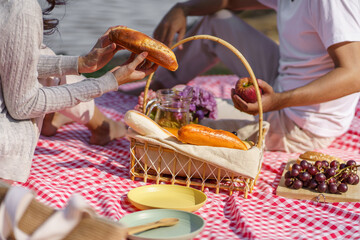 In love couple enjoying picnic time in park outdoors Picnic. happy couple relaxing together with picnic Basket