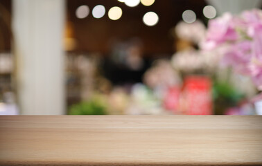 Empty wooden table in front of abstract blurred background of coffee shop . can be used for display or montage your products.Mock up for display of product
